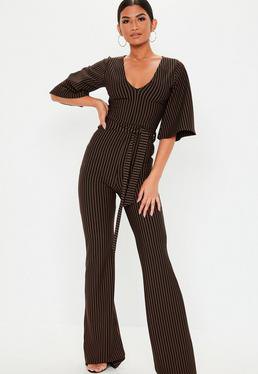 Black and white jumpsuit with vertical stripes and V-neck and wide sleeves