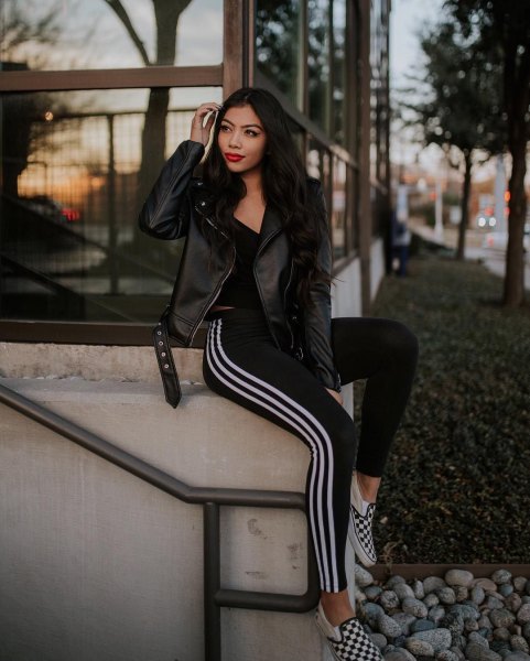Leather moto jacket with black and white adidas tights