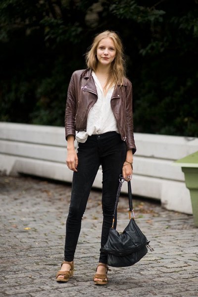 black moto jacket with white linen shirt and brown leather sandals