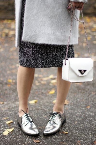 white wool coat with black printed midi shift dress and silver evening shoes