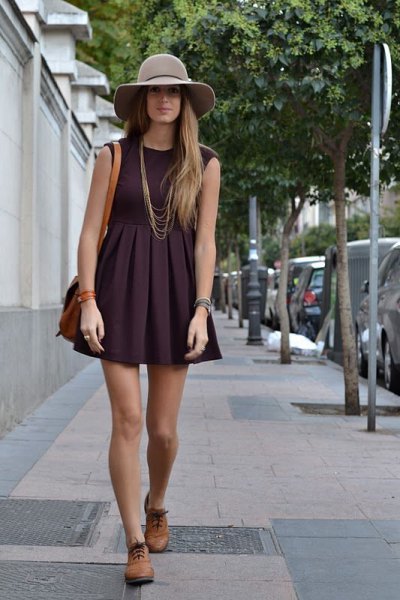 black sleeveless, flaky mini dress with brown oxford shoes