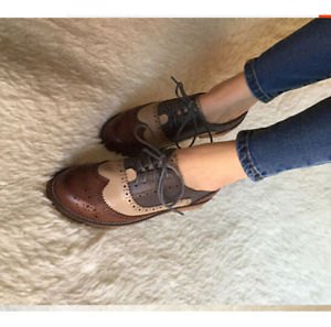 brown wingtip shoes with dark skinny jeans