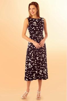 medium-length black and white polka dot dress with open toe heels