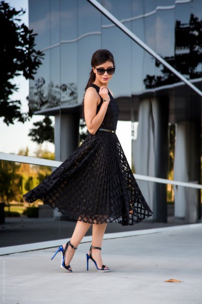 black sleeveless, medium length, flared dress with open toe heels