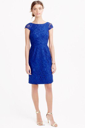 knee-length dress with cap sleeves in royal blue and gathered waist and silver heels