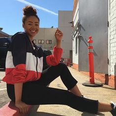 black white and red windbreaker with short skinny jeans