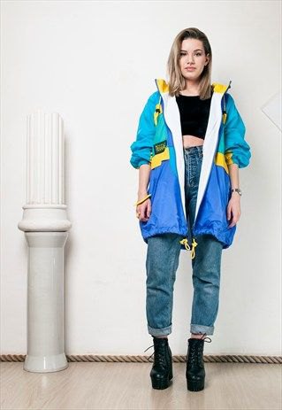 blue-pink and yellow windbreaker with black crop top and high-rise jeans