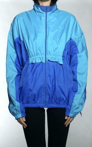 royal blue and teal windbreaker with black skinny jeans