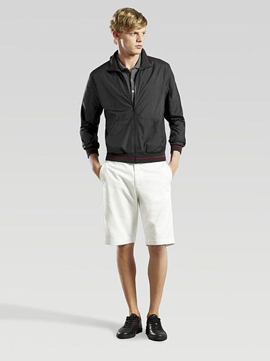 black windbreaker with white knee-length shorts