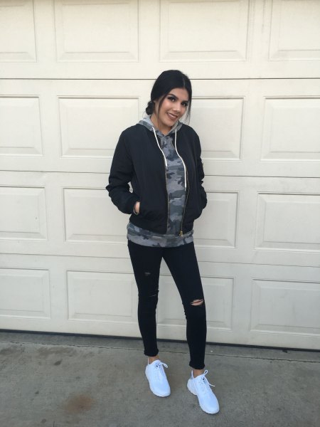 gray graphic hoodie with black Nike windbreaker and jogging tights