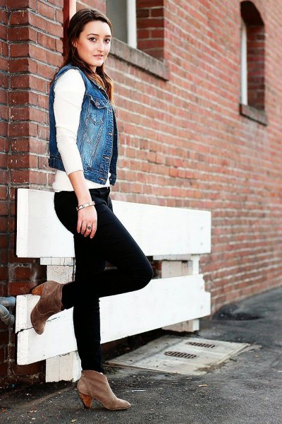 blue jeans motorcycle vest with white sweater and black jeans