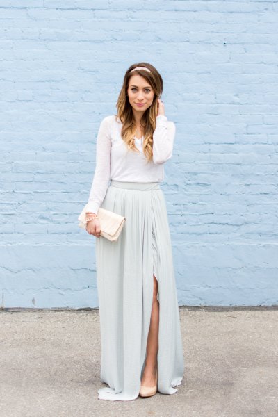 Long sleeve floor-length dress with gathered waist and white clutch