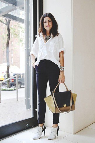 white oversized shirt with high dress pants and light gray boots with heels