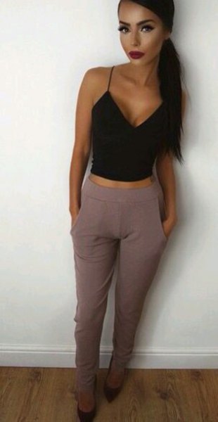 black, short vest top with a deep V-neck and gray, high-waisted suit pants