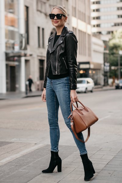 black leather moto jacket with gray-blue skinny jeans and boots with heels