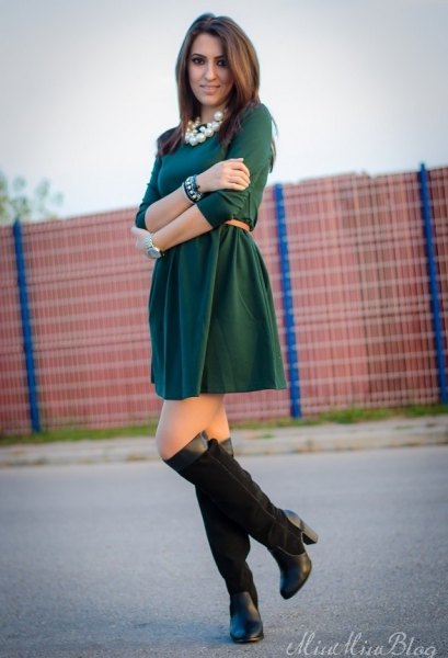 dark green dress with black high-heeled boots