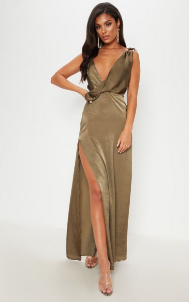 deeply slit khaki maxi dress with deep V-neck and silver, open toe heels