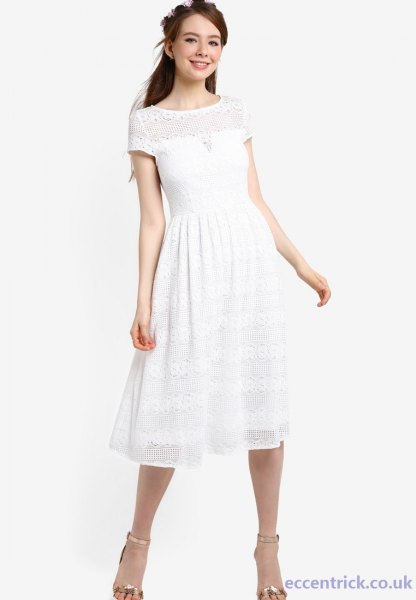 white, short-sleeved party dress with fit and flap and silver, open toe heels