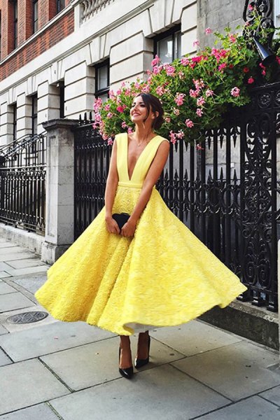 yellow lace fit and flare midi dress with deep v-neck and black heels