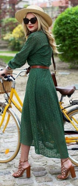 green long-sleeved midi dress with belt and straw hat