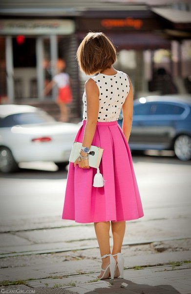 sleeveless blouse with white and black polka dots and pink pleated midi skirt