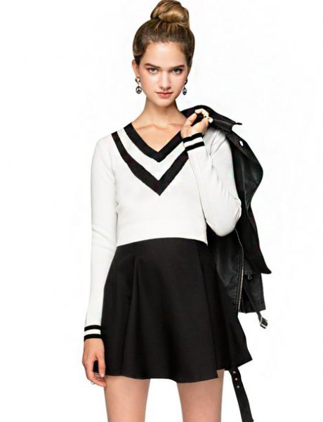 white and black sweater with V-neck and high waisted mini-skirt