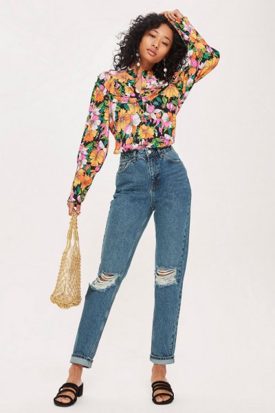 black blouse with floral pattern and blue torn jeans