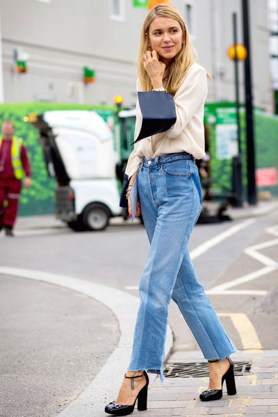 white sweater with a relaxed fit and blue mom jeans