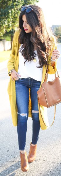 yellow longline cardigan sweater with white blouse and torn knee jeans
