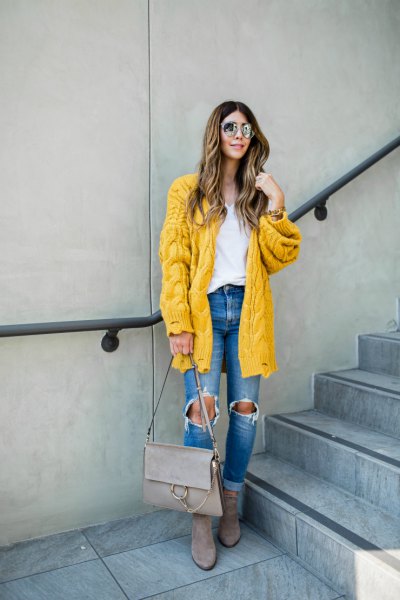 Cable pattern lemon yellow cardigan with blue destroyed jeans