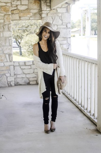 black tank top with a scoop neckline, white cardigan and floppy hat