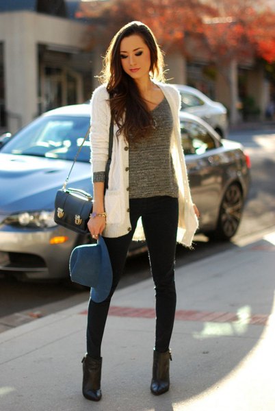 white cardigan with gray knitted sweater with scoop neck and black skinny jeans