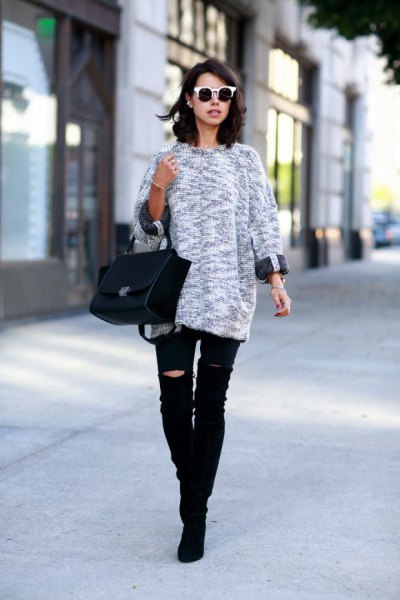 gray mottled knit sweater with black, torn knee jeans
