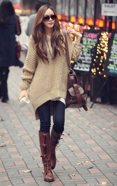 blush pink large sweater with navy skinny jeans and brown boots