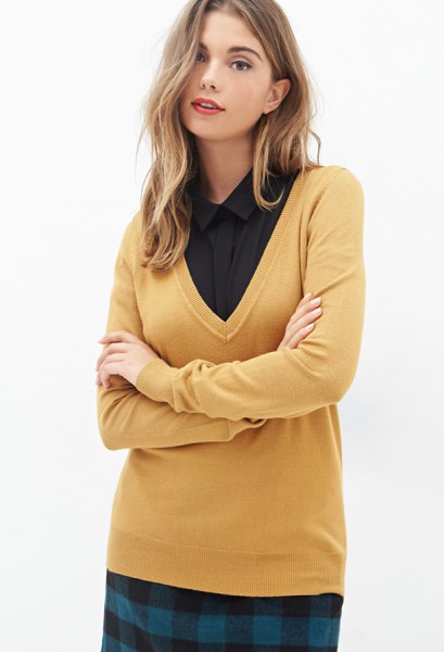 mustard yellow sweater with V-neck and black shirt with buttons