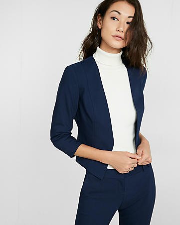 deep blue blazer with matching chinos and white sweater with stand-up collar