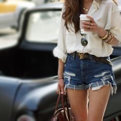 white linen shirt with a relaxed fit and torn blue denim shorts
