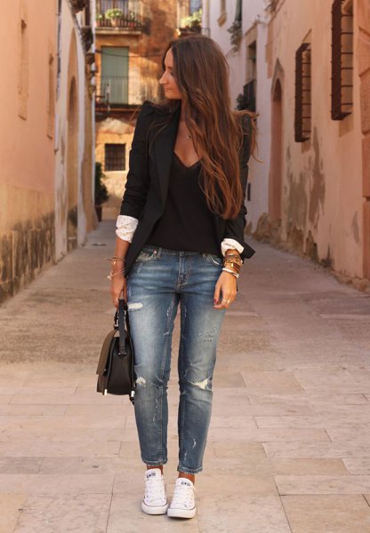 black blazer with deep v-neck blouse and blue torn jeans