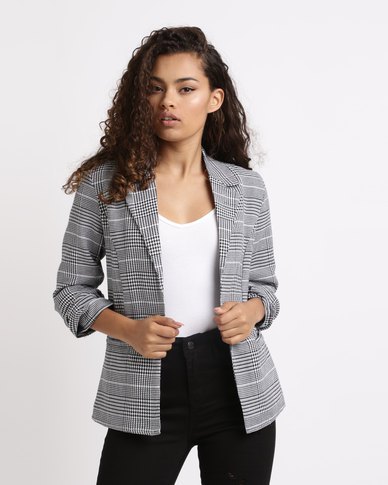 checkered blazer with white tank top and black high-rise jeans