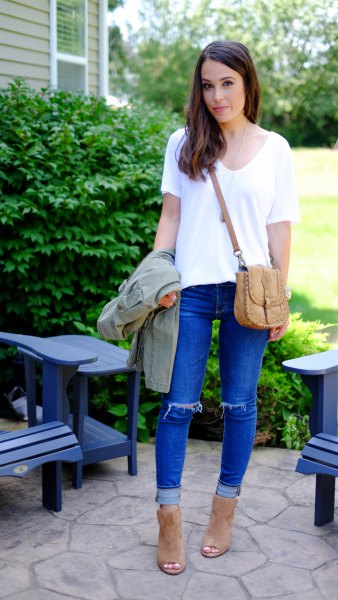 white t-shirt with v-neck and blue torn jeans with cuff