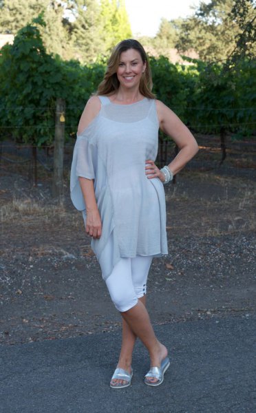 light gray tunic blouse with cold shoulder and silver sandals