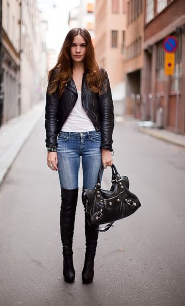 black slim fit leather jacket with blue skinny jeans and flat long boots