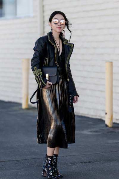 black maxi jacket with pleated midi skirt and star-studded ankle boots with heel