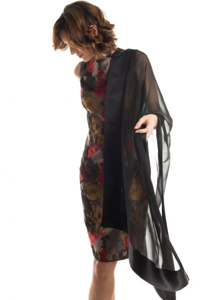 black chiffon cape with a dark, form-fitting midi dress with a floral pattern