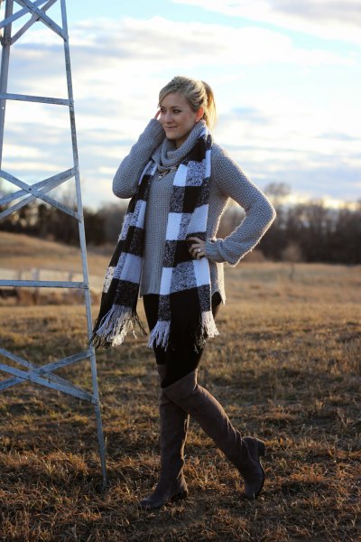 gray sweater with a waterfall neckline and checkered fringed scarf