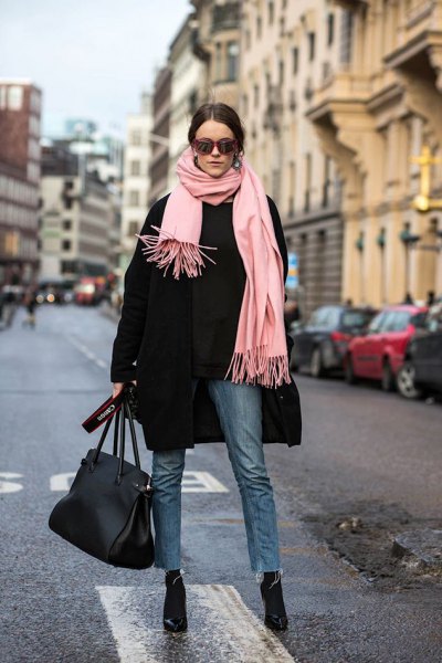 black wool coat with light pink fringed scarf and black, slim fit jeans
