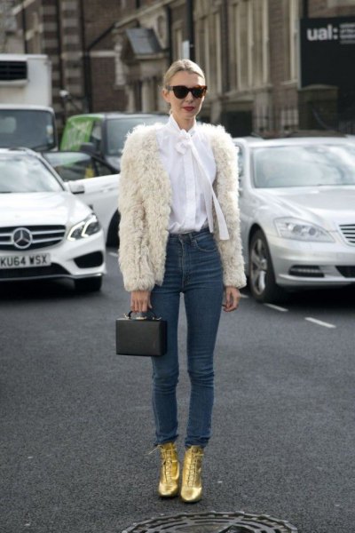 white faux fur jacket with white bow shirt and golden boots