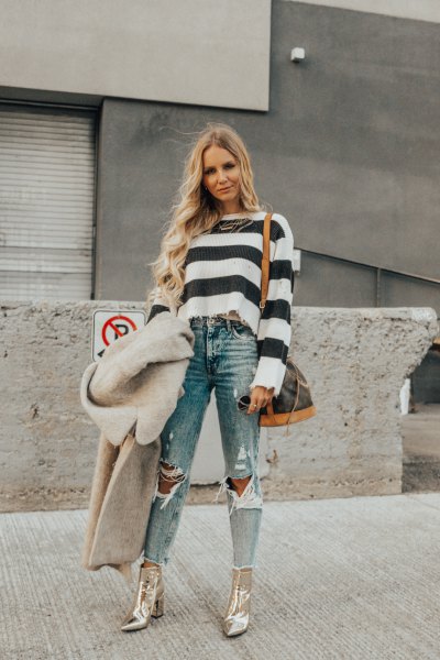 black and white striped sweater with torn jeans and gold boots