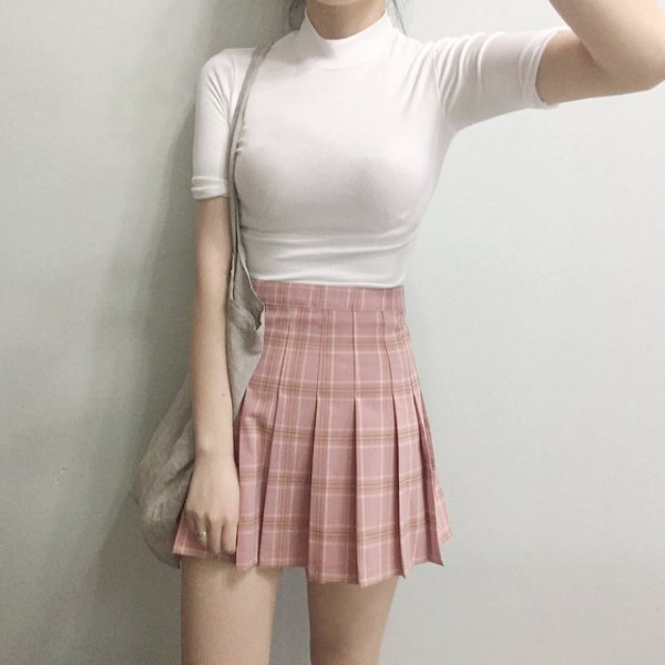 black, form-fitting t-shirt with stand-up collar and pink pleated mini skirt
