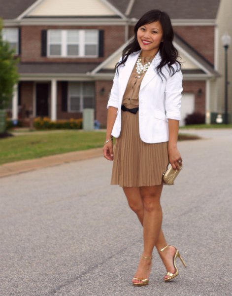 white blazer with blushing pink mini pleated skirt and gold heels